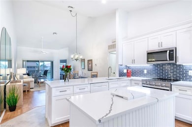 Kitchen featuring open floor plan, a peninsula, st