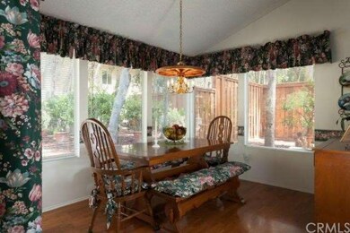 Formal dining area with wood floors, and lots of l