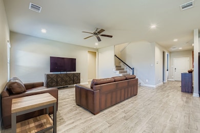 Living area with recessed lighting, stairway, light wood-type flooring, and a ceiling fan