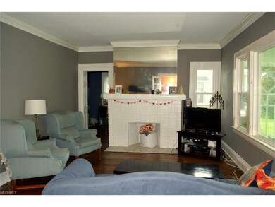 First floor living room with hardwood floor and decorative fireplace