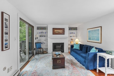 Living room with gas fireplace with slider to the deck