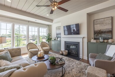 Living room with ceiling fan and wood-type floorin