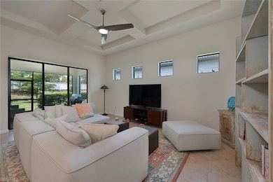 Living area featuring coffered ceiling, a ceiling 
