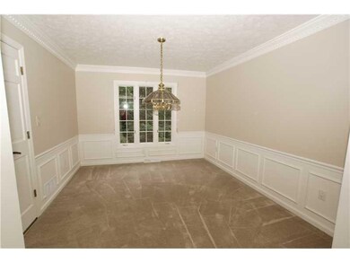 Dining Room. Dining room has a complimentary window to the living room, wainscoting and wide crown and dentil trim. The thoughtful addition of the double French doors adds a more formal feeling keeping cooking, clanging and preparation area separate.