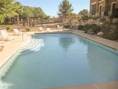 Community pool with a patio