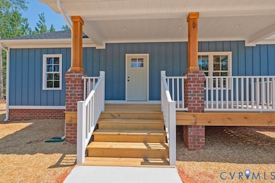 Property entrance featuring board and batten siding and covered porch