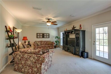 The open floor plan makes the living room convenient to the kitchen area and back patio; perfect for entertaining! 