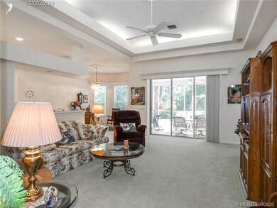 Family room opening up to extended screened patio