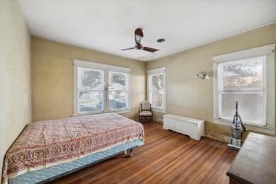 The spacious bedroom in the main house is filled w