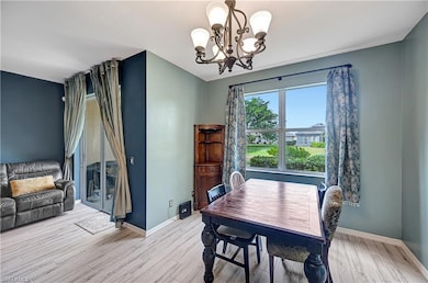 Dining space with a chandelier and light hardwood 