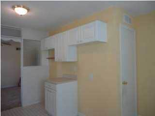 View of the wall, where the refrigerator and stove