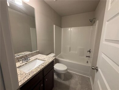 Bathroom with toilet, vanity, and bathing tub / shower combination