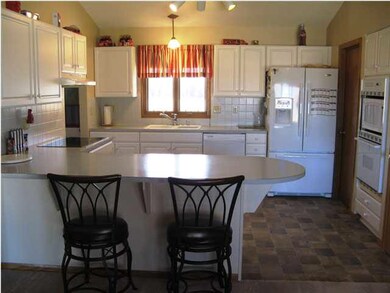 Large eating bar in kitchen is ideal not only for 