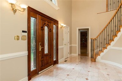 Dramatic custom curved staircase and marble tile f