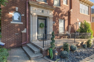 View of exterior entry featuring brick siding