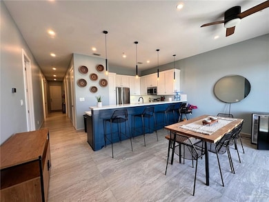 Dining room featuring recessed lighting, wine cooler, and ceiling fan