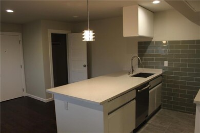 Kitchen featuring a sink, dishwasher, white cabin