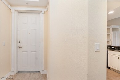 Hall featuring light tile patterned floors