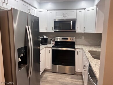 Kitchen with stainless steel appliances, light sto