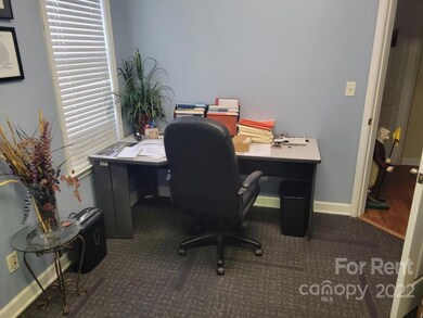 Furnished with two desks and one chair.