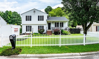 Split level home featuring a porch and a fenced fr