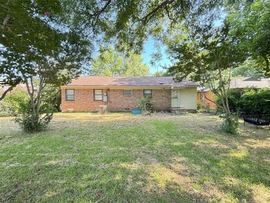 Rear view of house featuring a lawn