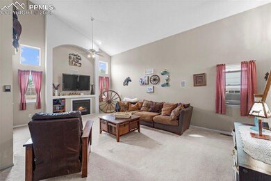 Living room with ceiling fan, high vaulted ceiling