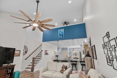 Living room with stairs, wood finished floors, rec