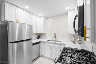 Kitchen with stainless steel appliances, light sto