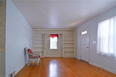 Living room, bookshelves and shutters on the side window.