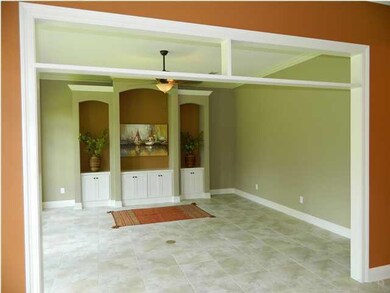 The family room is cozy and inviting, situated just off the kitchen, with built in entertainment center.