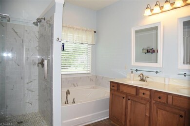 Master bath with tile shower, garden tub, double sinks.