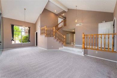 Unfurnished living room with high vaulted ceiling,