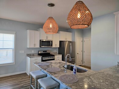 Kitchen with white cabinets, stainless steel appli