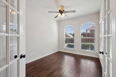 The Office featuring french doors, dark wood finished floors, and a ceiling fan