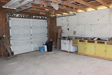 Large garage door and lots of benches & storage