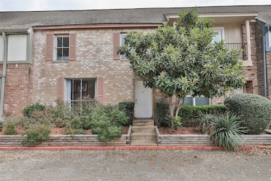 This charming townhouse features a classic brick e