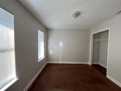 Unfurnished bedroom featuring a textured ceiling,