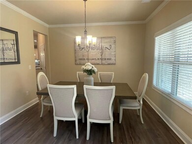 Dining space featuring a notable chandelier, dark 