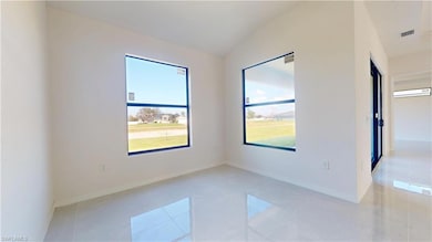 Unfurnished room with light tile patterned floors,