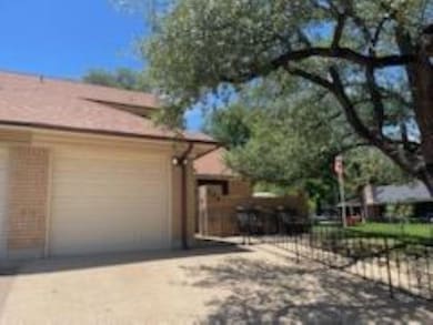 View of side of home featuring concrete driveway