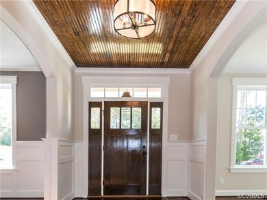 Large foyer with wainscoting and crown modling