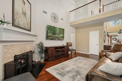 This charming two-story brick home features a well-maintained front yard with mature trees and landscaping. It has a double garage and a welcoming entrance, perfect for families seeking a comfortable and inviting residence.