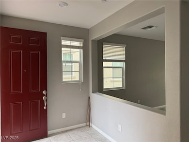 Entrance foyer featuring baseboards, tile patterne