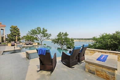 View of pool with a patio area, a water view, and