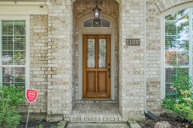 Charming brick entryway featuring a wooden front d