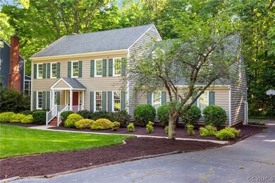 Colonial inspired home featuring a front yard