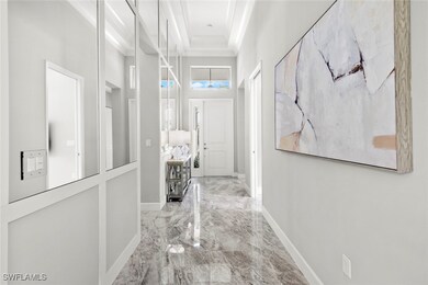 Corridor with ornamental molding, a towering ceili