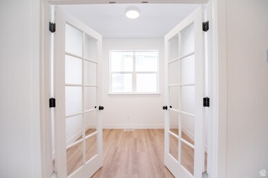 Convenient office/den adjoining kitchen with french doors.