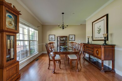 Lovely dining room looking out to a wooded pocket park.